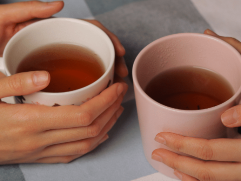 Hands cupping warm drinks