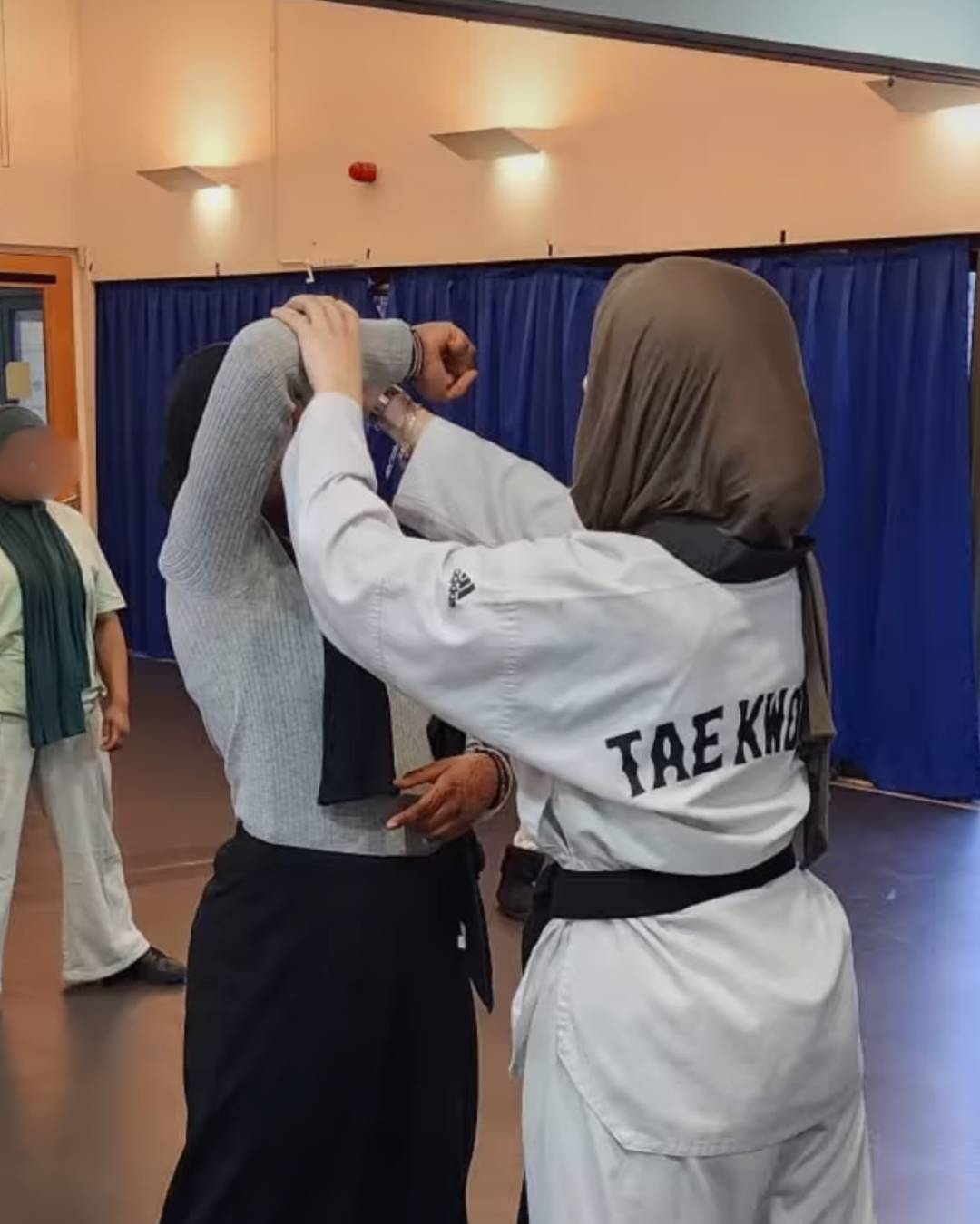Two women are taking part in a self defense class at Poplar Union