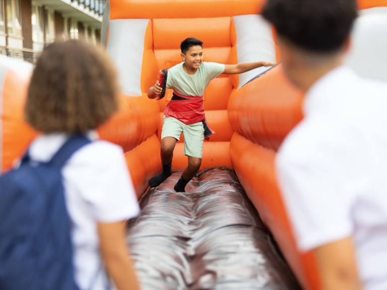 A young boy plays on the bungee sprint game at a Summer of Wellbeing Festival in Mile End
