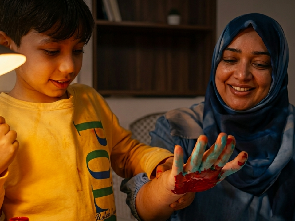 A mother and son are hand painting